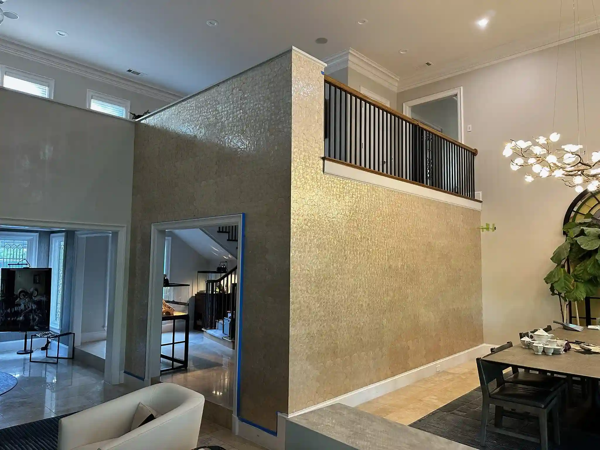 A living room with a textured feature wall and neutral furnishings